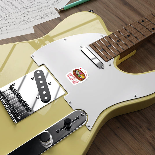 Electric Guitar with Sticker and Sheet Music Surrounding