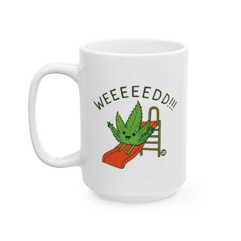 Load image into Gallery viewer, White ceramic coffee mug with a cartoon cannabis leaf sliding down a playground slide and the text ‚ÄúWEEEEEED!!!‚Äù

