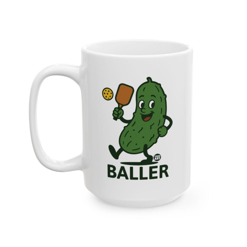 Load image into Gallery viewer, White ceramic mug featuring a pickle character holding sports equipment with the word ‚ÄúBaller,‚Äù designed by Todd Art
