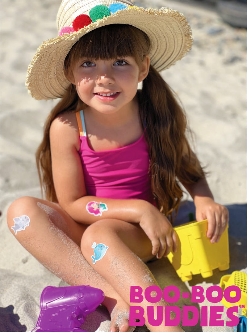 Load image into Gallery viewer, Kid wearing Boo Boo Buddies Bandages at the beach
